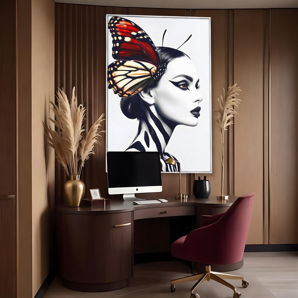 Tablou canvas cu tablou canvas cu femeie si aripa de fluture, in rama de aluminiu argintiu, pe perete intr-un birou